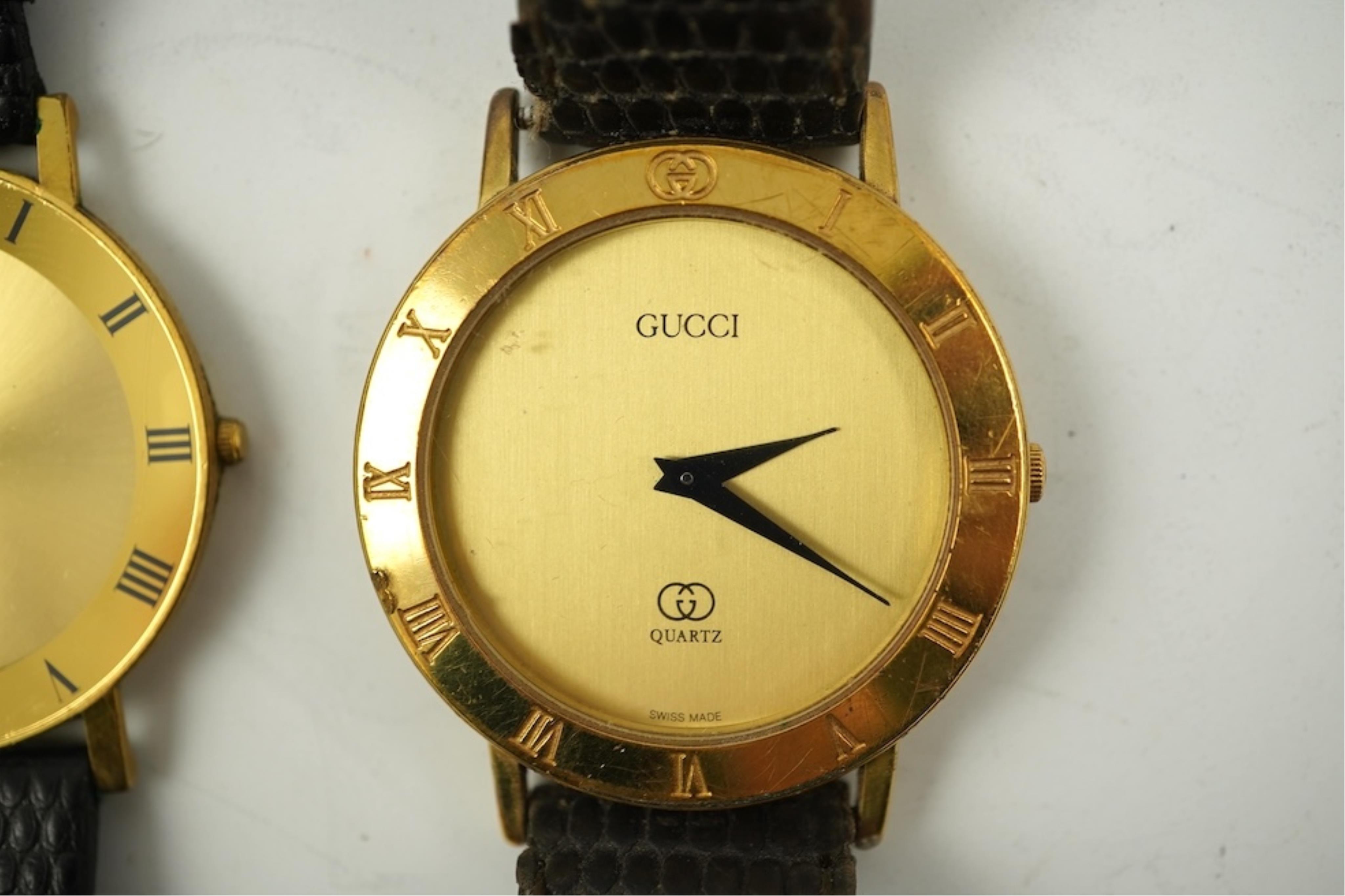 A gentleman's recent 18k gold electro-plated Raymond Weil quartz dress wrist watch, case diameter 33mm and a similar Gucci quartz dress wrist watch.